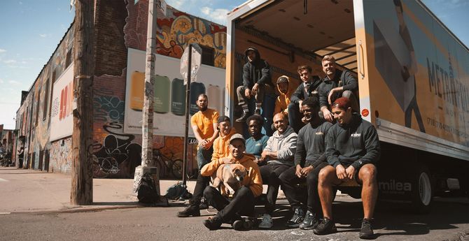 Men smiling at the back of truck