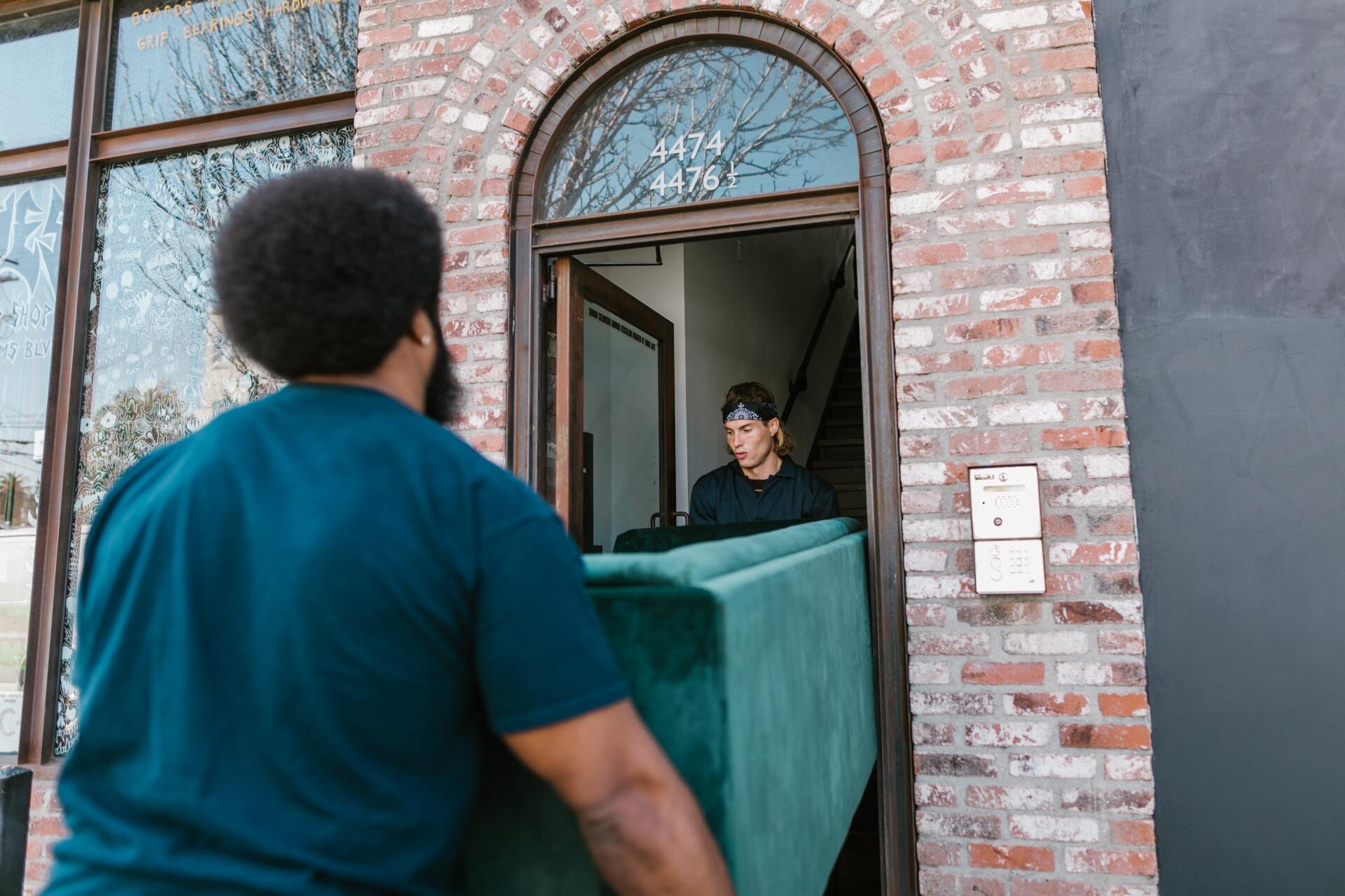 Two man carrying a furniture