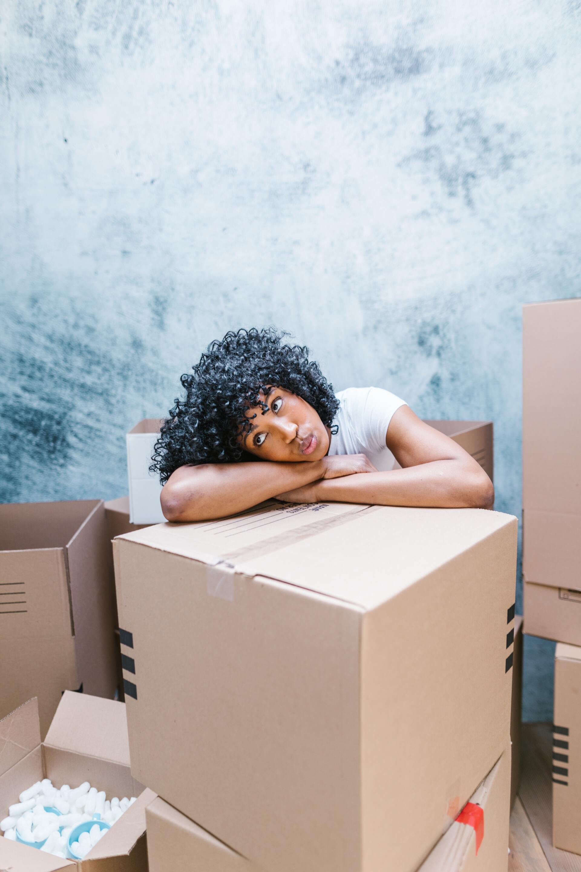 Woman leaning on the top of the box
