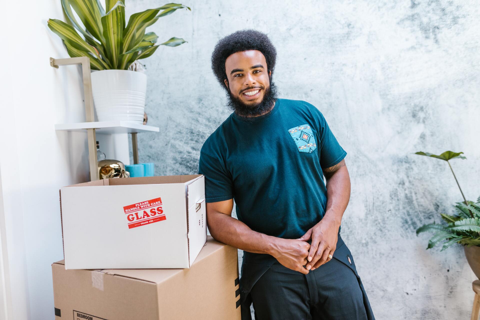 Man smiling beside the box