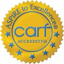 CARF Accredited seal with gold starburst, blue text on yellow: 