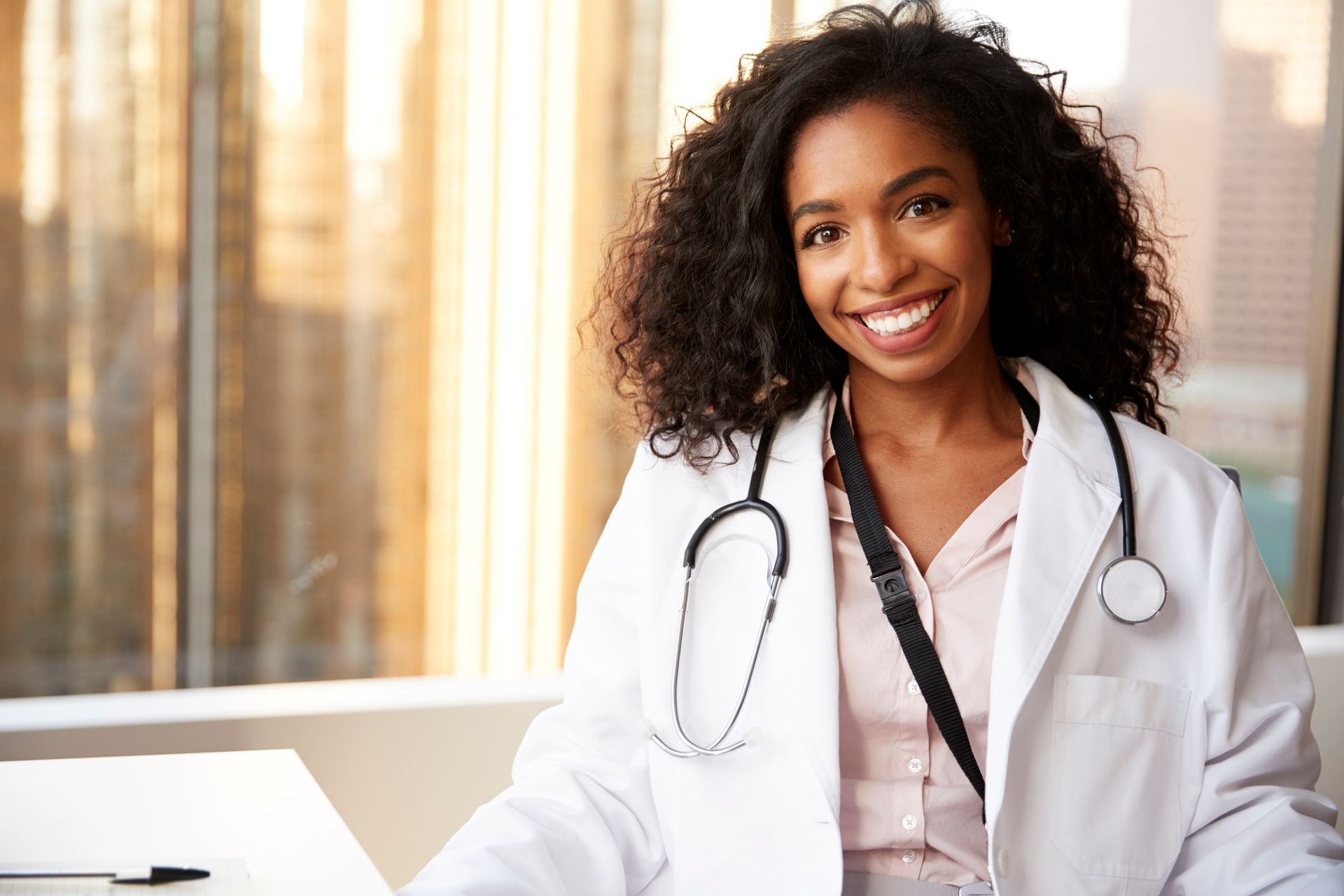 A doctor is listening to a patient 's heartbeat with a stethoscope.