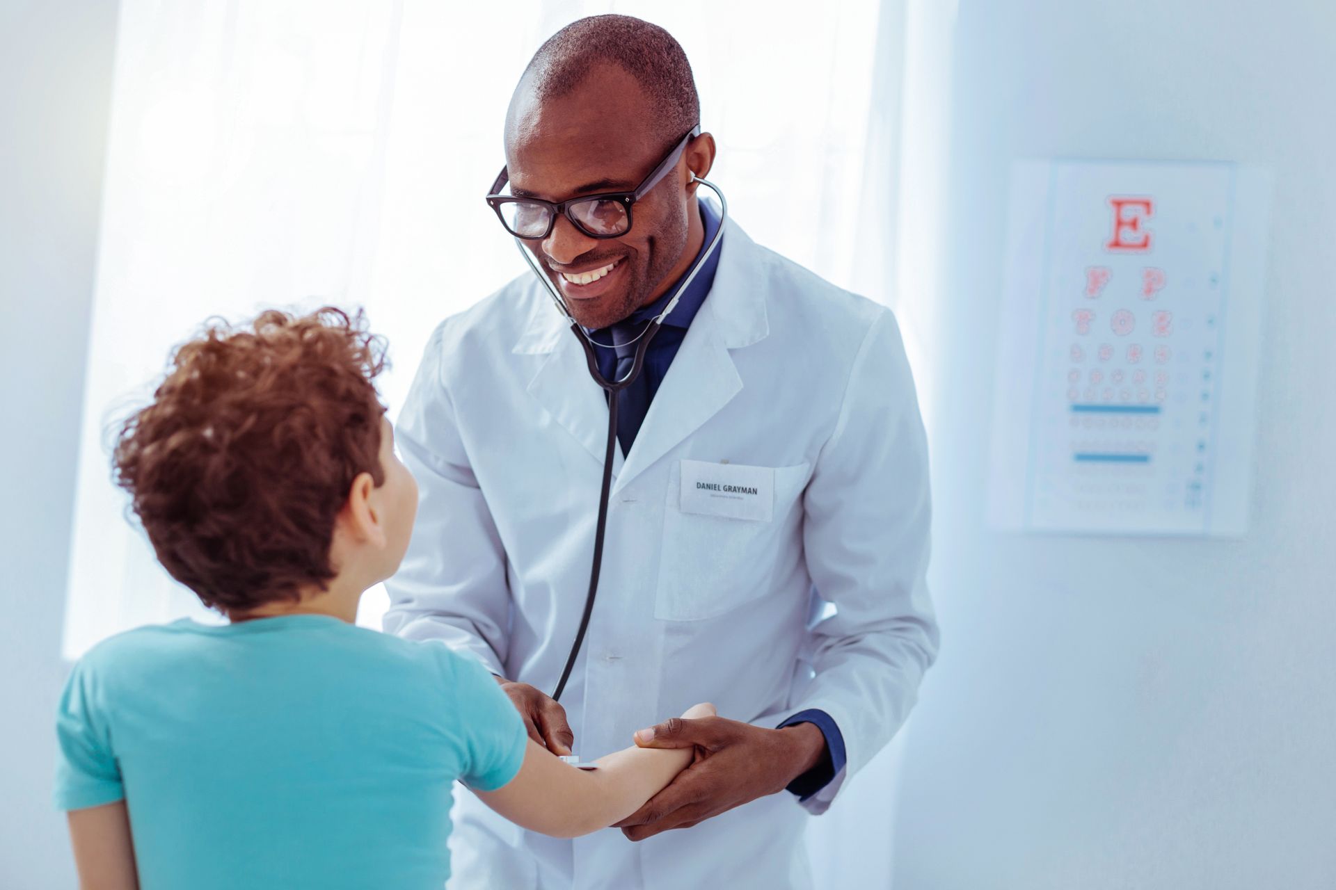 Doctor warmly examining a child in a bright clinic