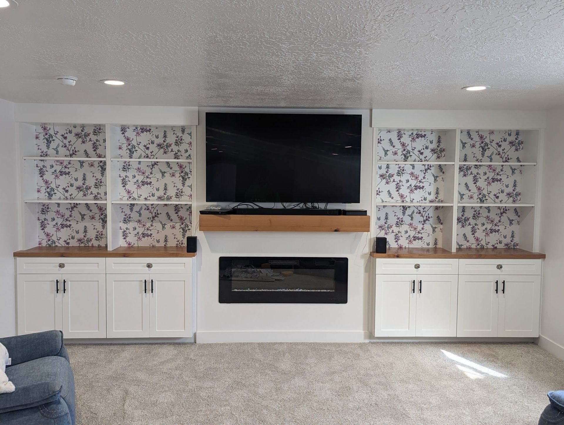 A living room with a fireplace and a flat screen tv.