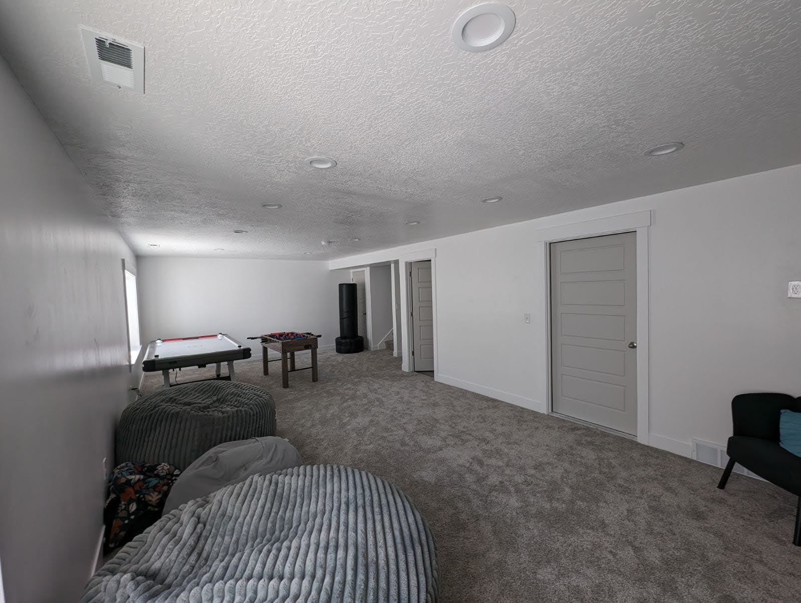 There is a pool table in the middle of the room.