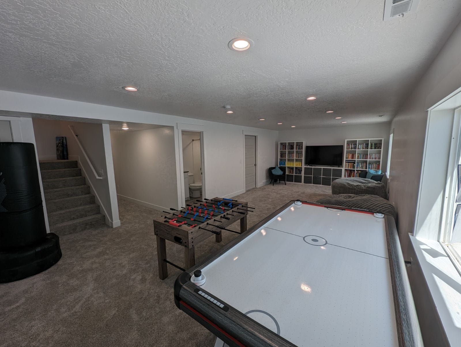 There is a pool table in the middle of the room.