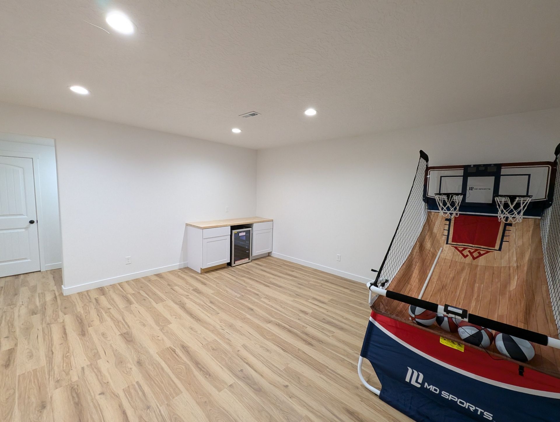 There is a basketball hoop in the middle of the room.