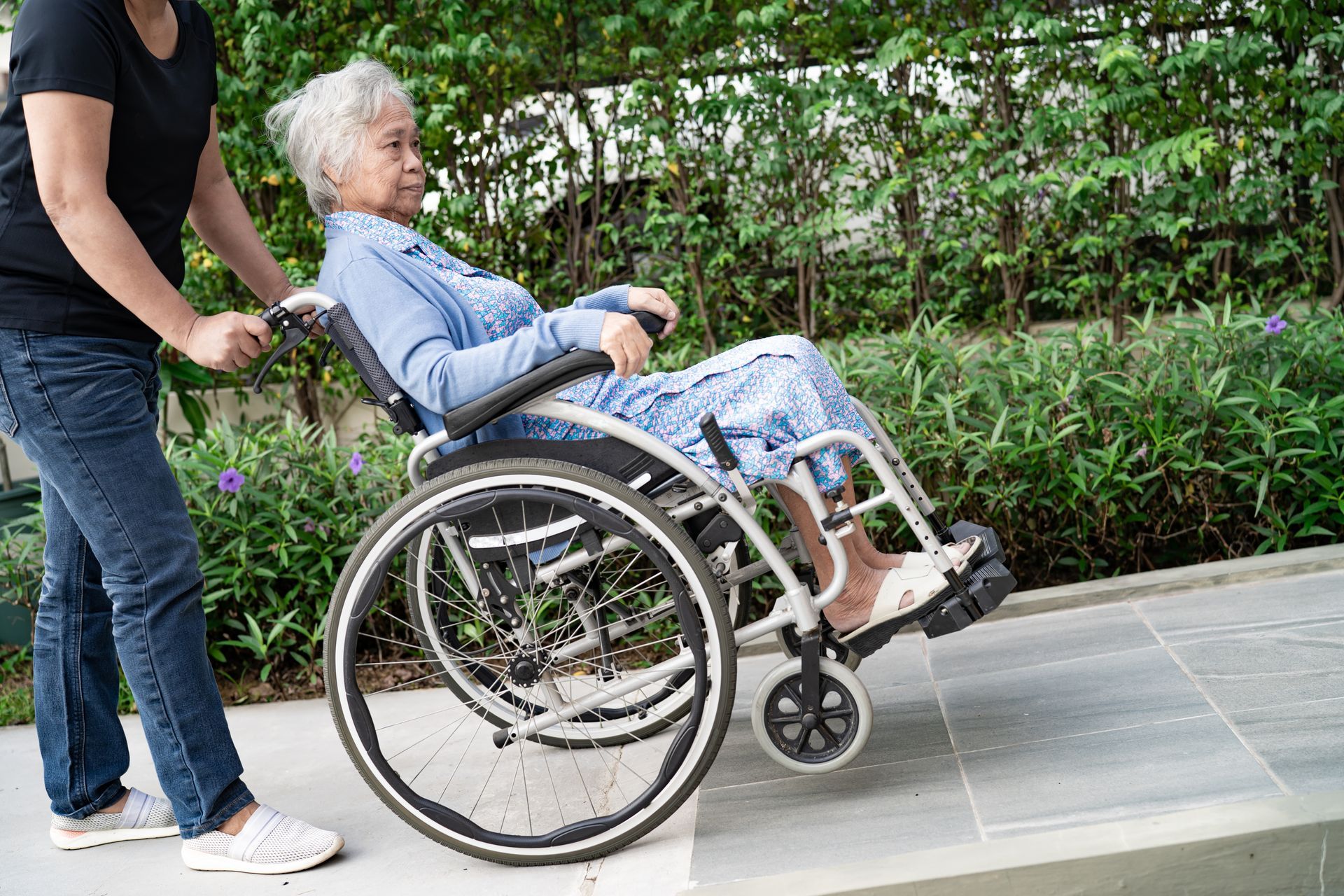 pushing wheelchair up a ramp