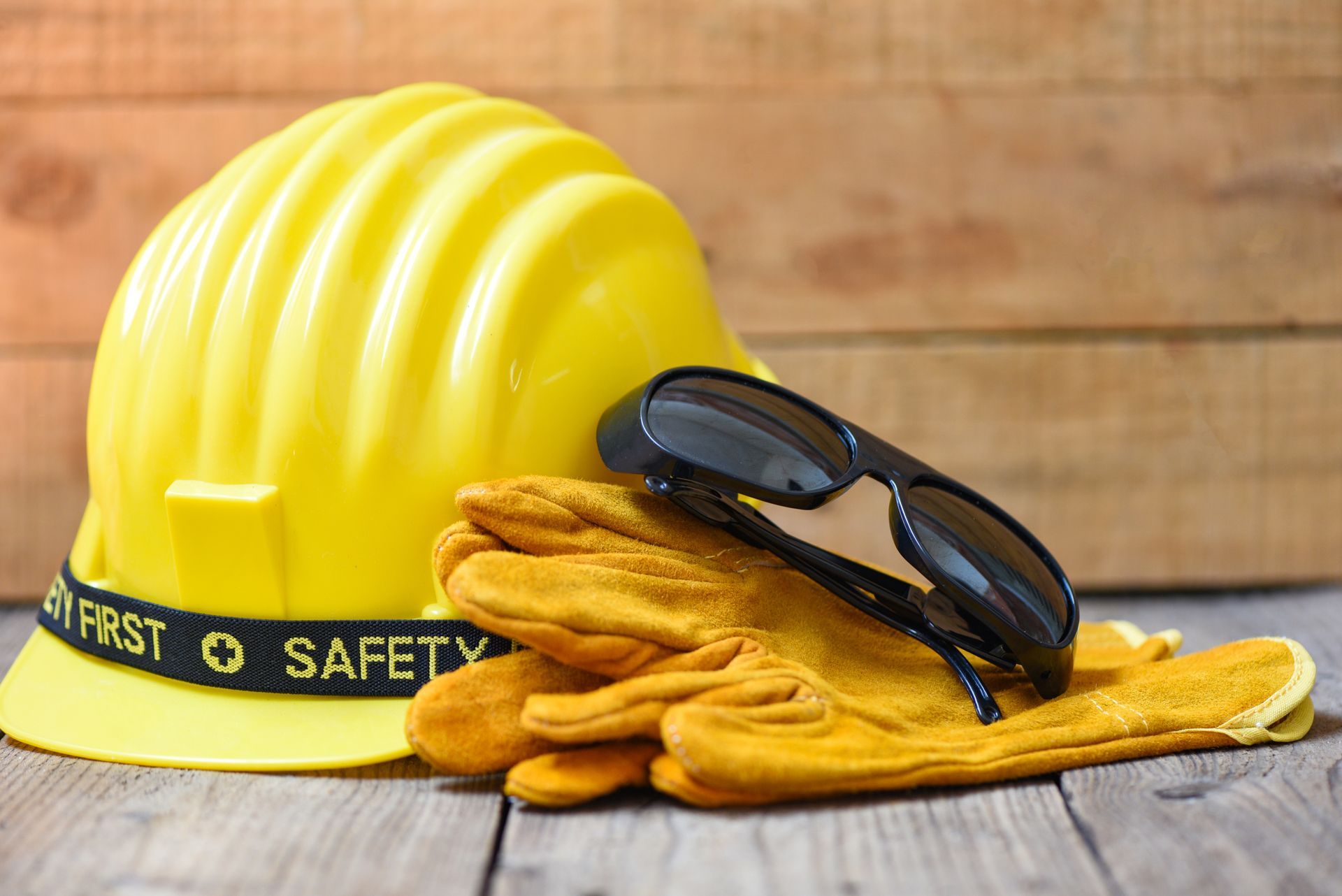 A safety construction hat, gloves, and sunglasses