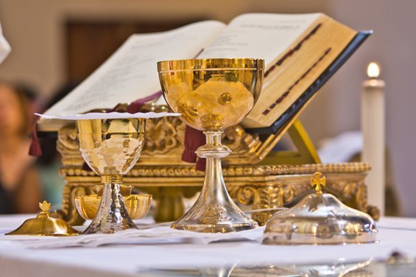 A chalice and a bible are on a table