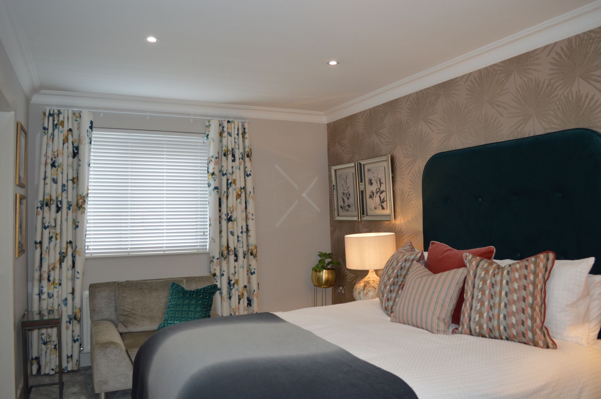 A bedroom with a king size bed and a couch.