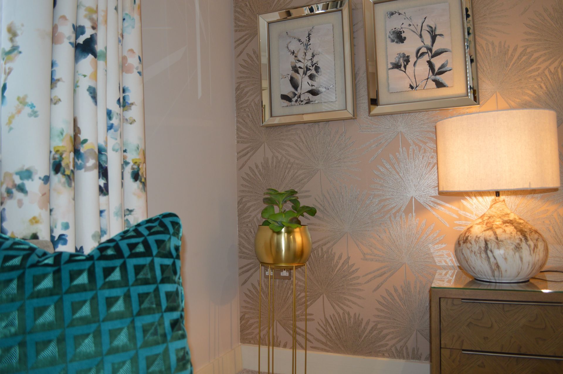 A lamp is sitting on a nightstand next to a chair in a room.