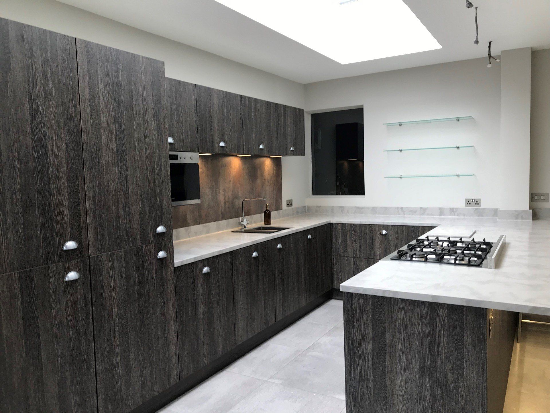 A kitchen with wooden cabinets and a stove top oven