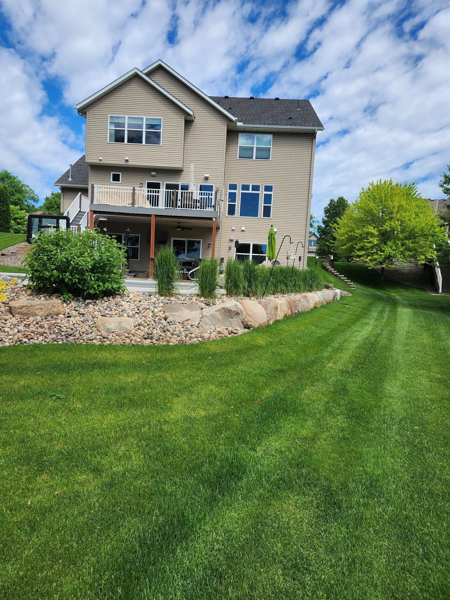 A large house with a lush green lawn in front of it.