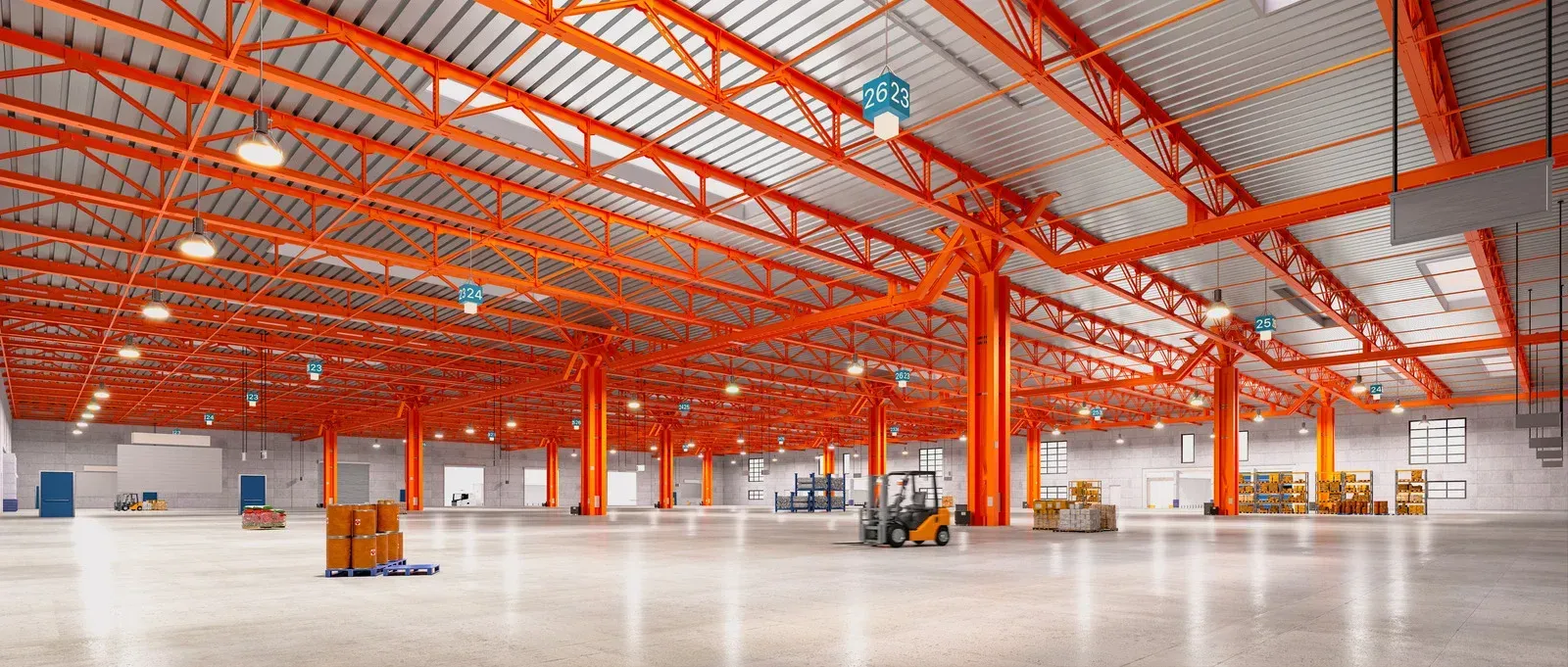 Empty warehouse interior with orange support beams and a few forklifts.
