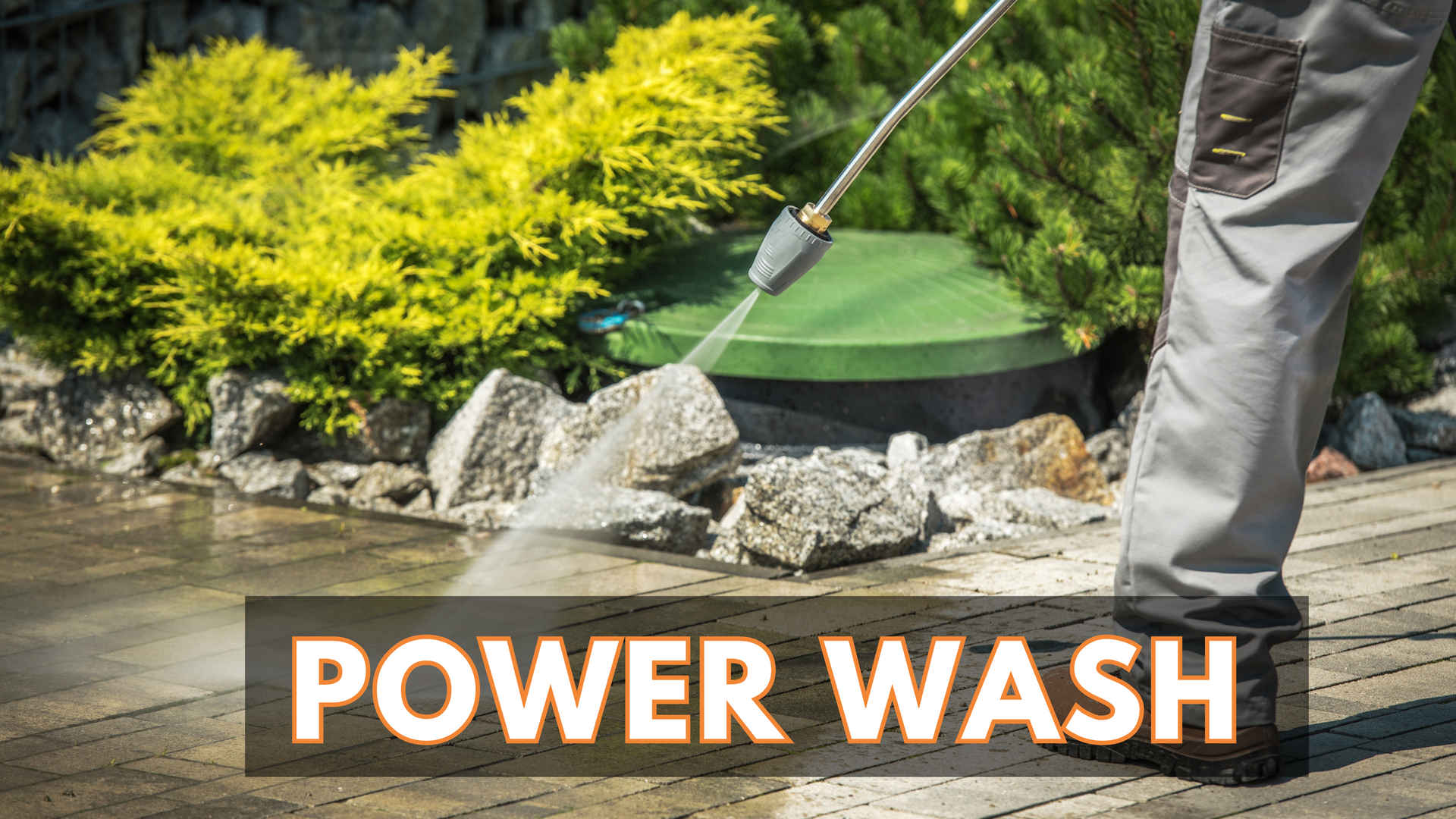 A person is using a power wash to clean a wooden deck.