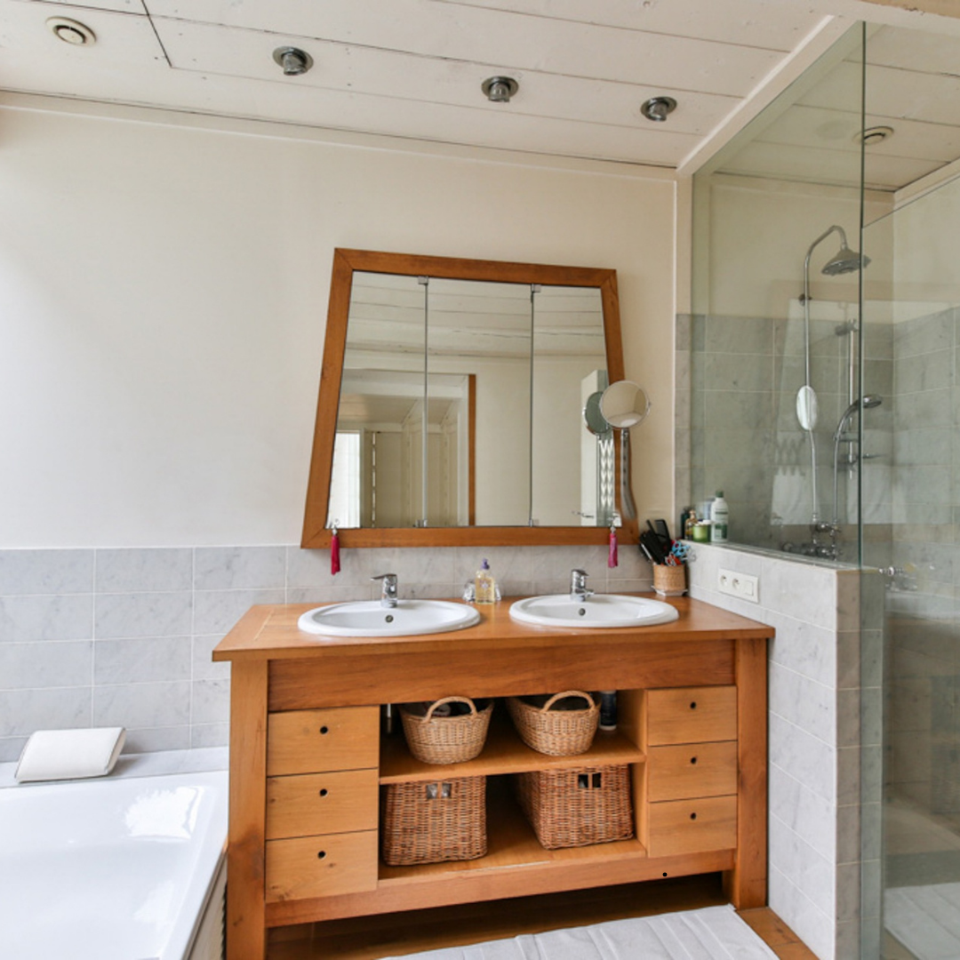 A bathroom with two sinks and a large mirror
