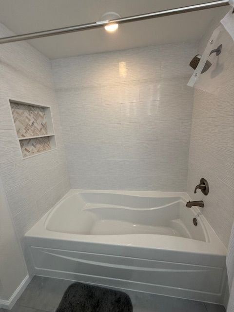 A bathroom with a bathtub and a shower by Dan Kaplan in Collegeville, PA