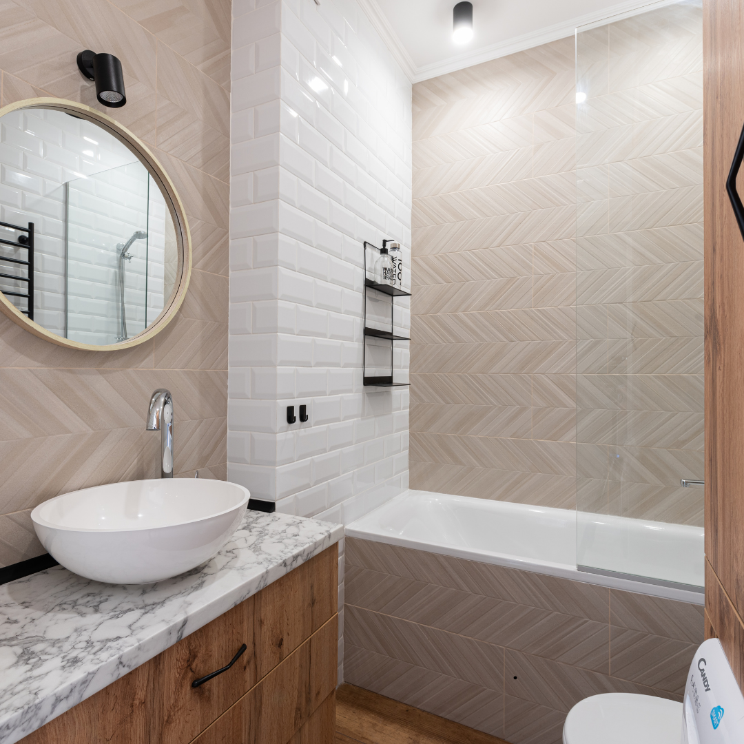 A bathroom with a toilet , sink , mirrors and a walk in shower.