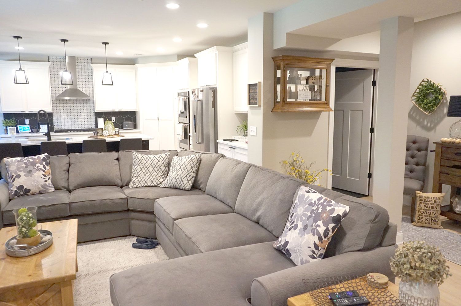 A living room with a large sectional couch and a coffee table.