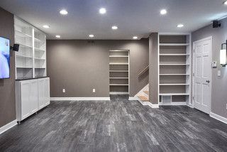 A basement with hardwood floors and a flat screen tv.