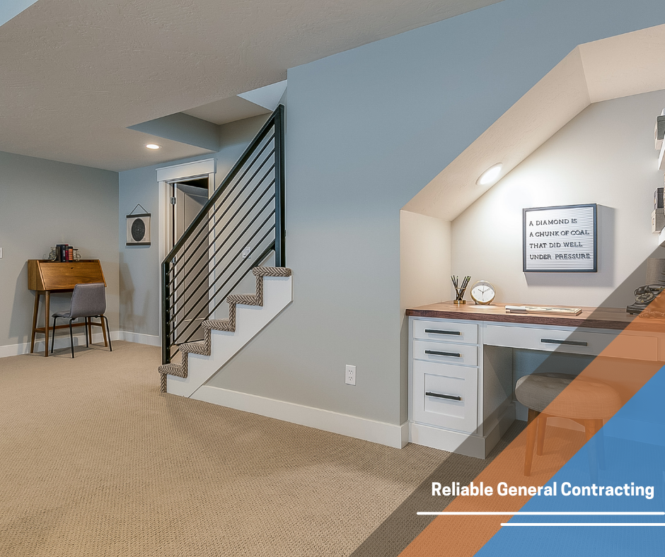 A basement with stairs and a desk under the stairs