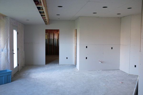 An empty room with white walls and a blue box on the floor