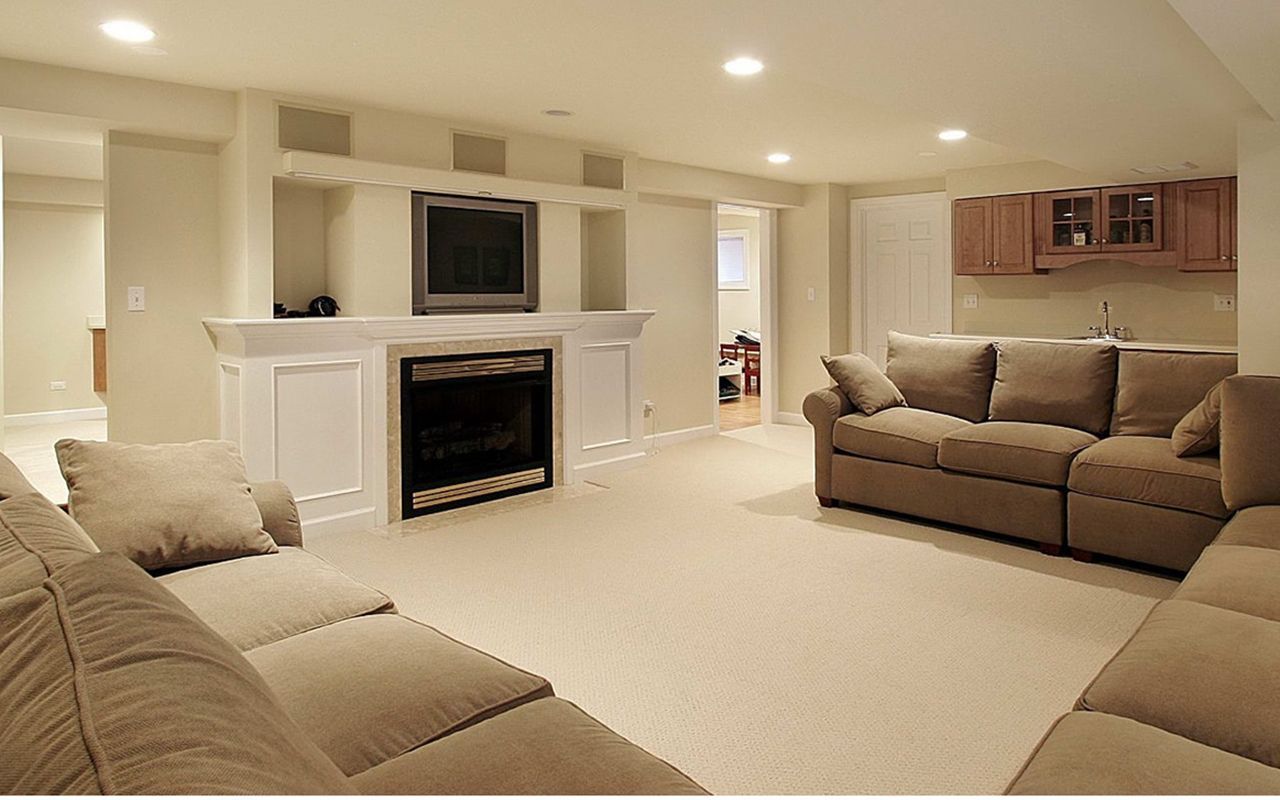 A living room with a couch , fireplace and television.