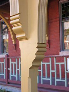 A red brick building with a yellow pillar in front of it
