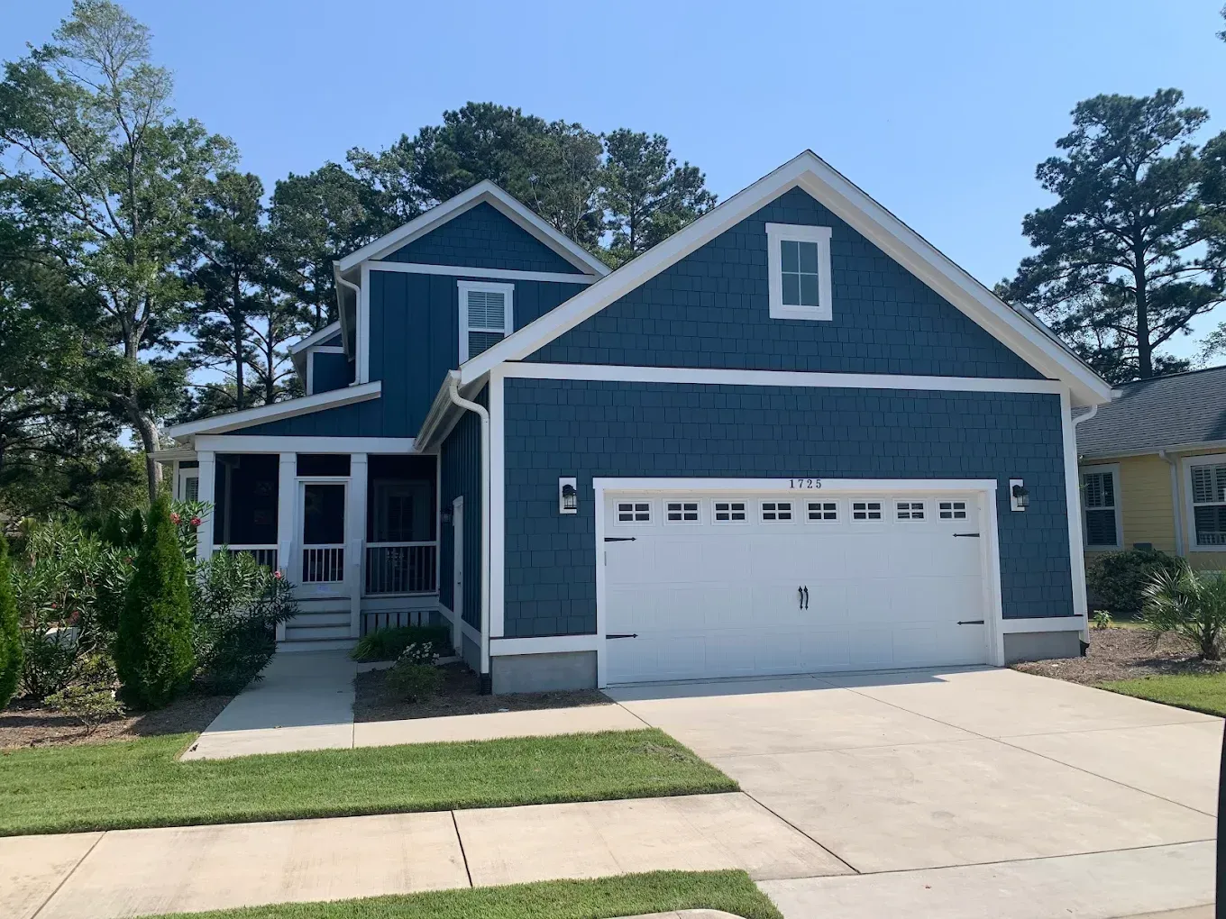 a finished exterior paint job of a Blue house with white trim located in Wilmington, NC