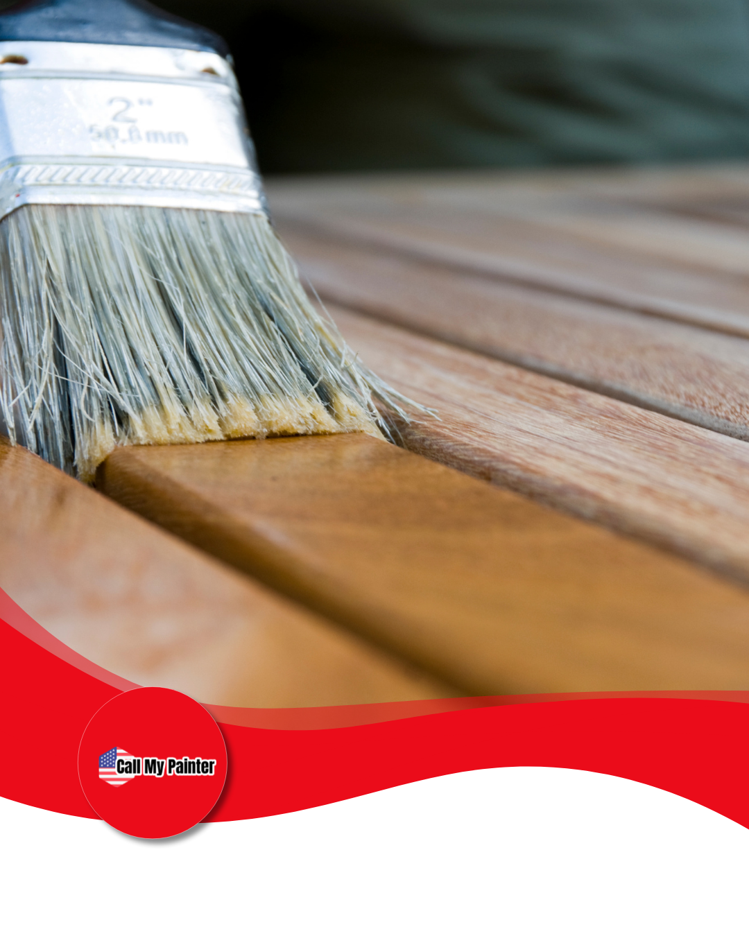 Paintbrush applying stain to wooden planks.