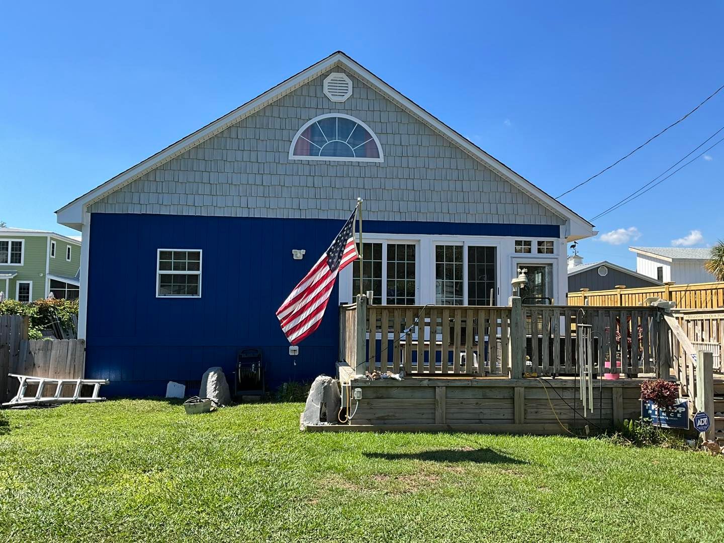 finished home with beige siding, white trim, and a circular window in Wilmington, NC