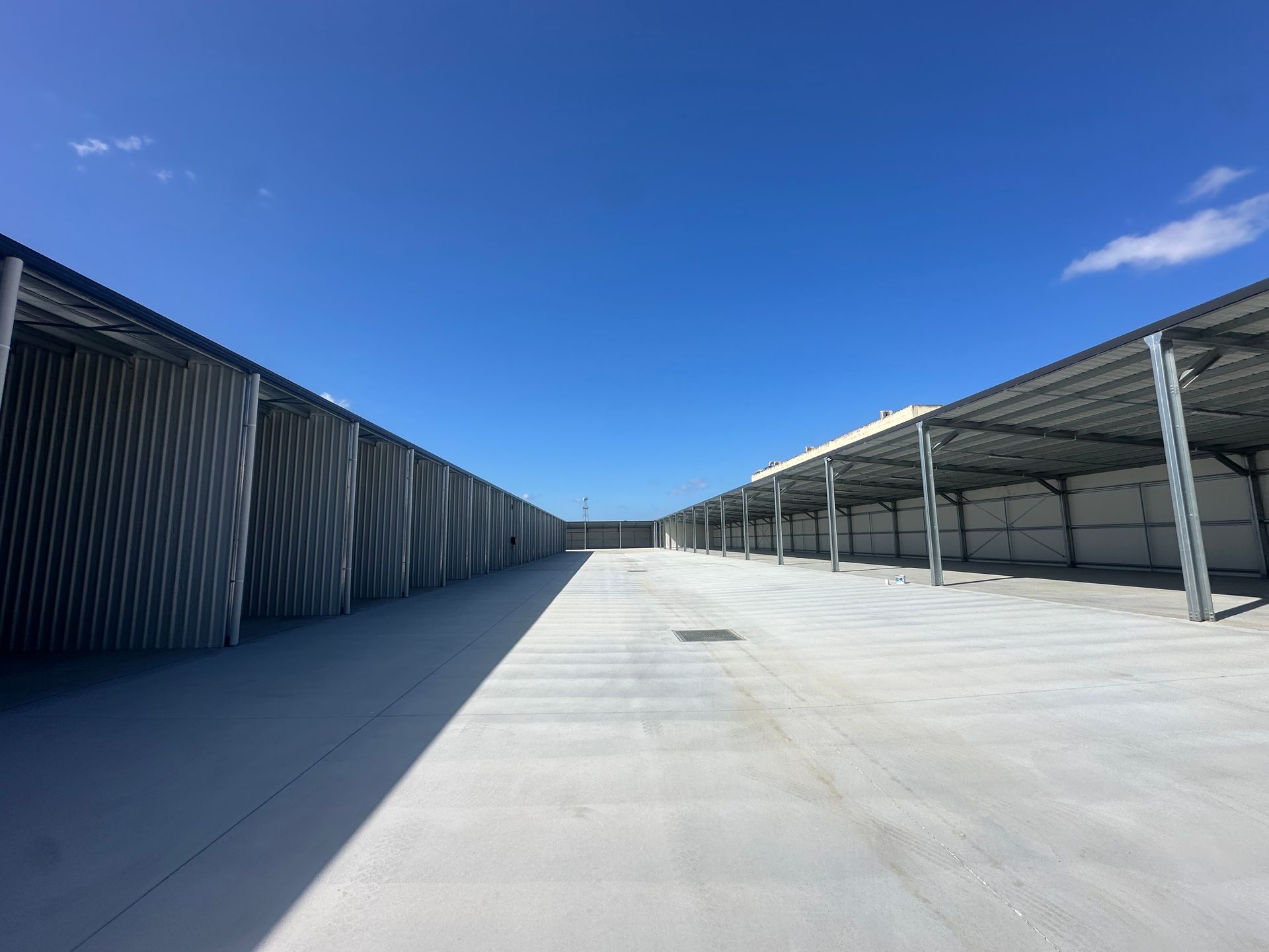 Exterior View of Long, Empty Concrete Storage Units — Midcoast Premium Caravan Storage in Forster, NSW