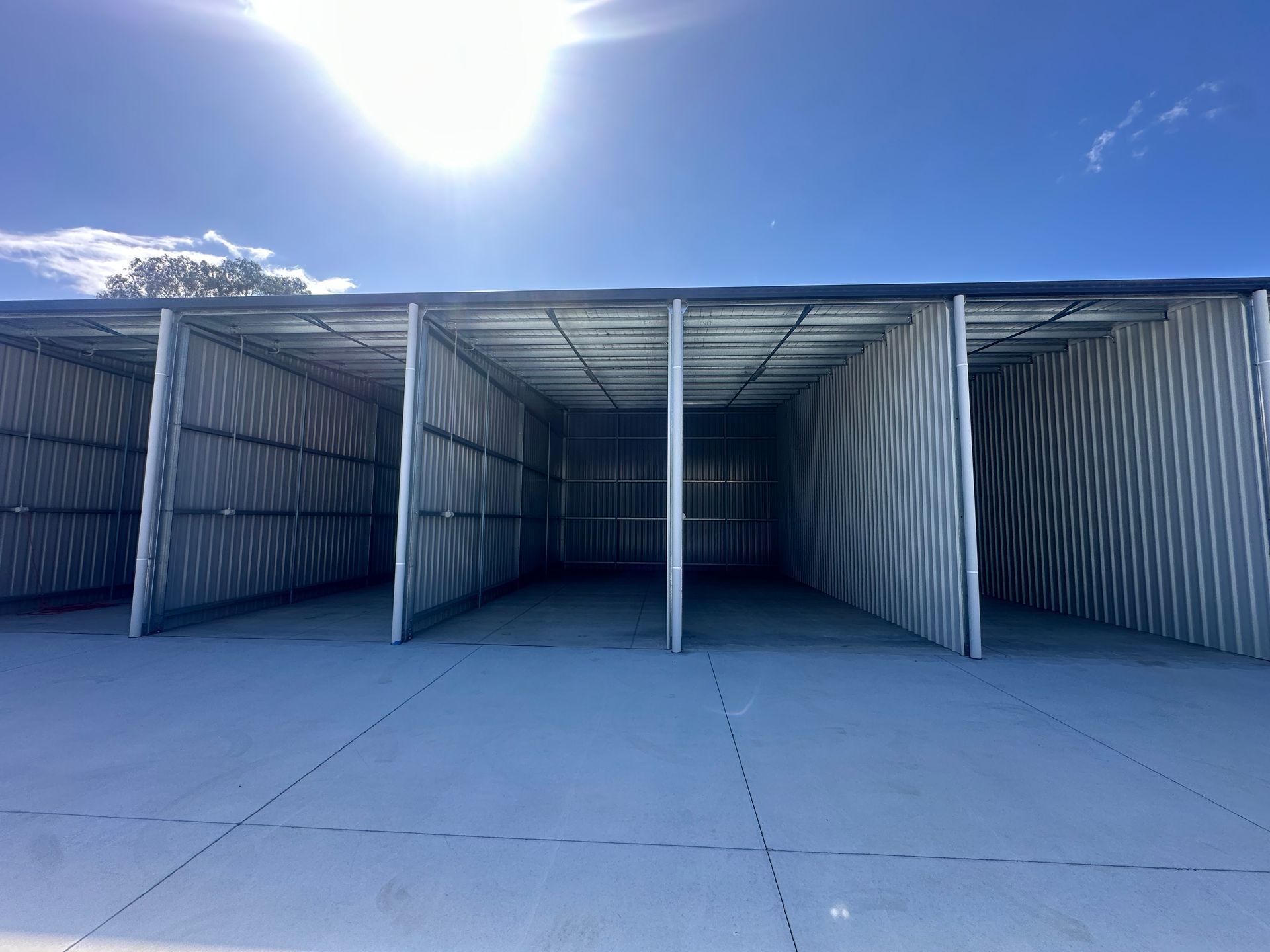 Empty, Metal Storage Units Against a Bright Blue Sky — Midcoast Premium Caravan Storage in Forster, NSW