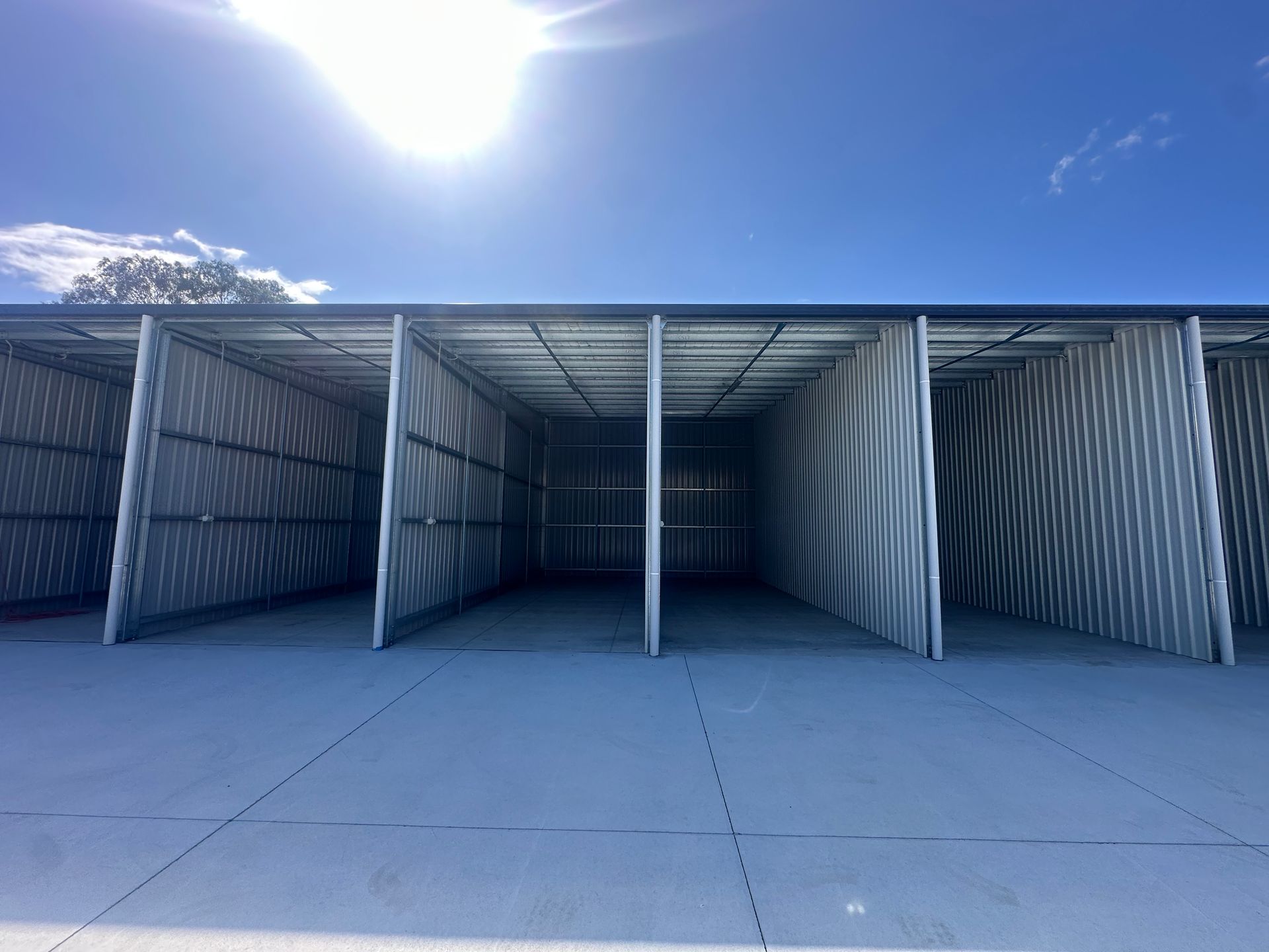 Open Storage Units With Corrugated Metal Walls, Under a Bright Sky — Midcoast Premium Caravan Storage in Forster, NSW