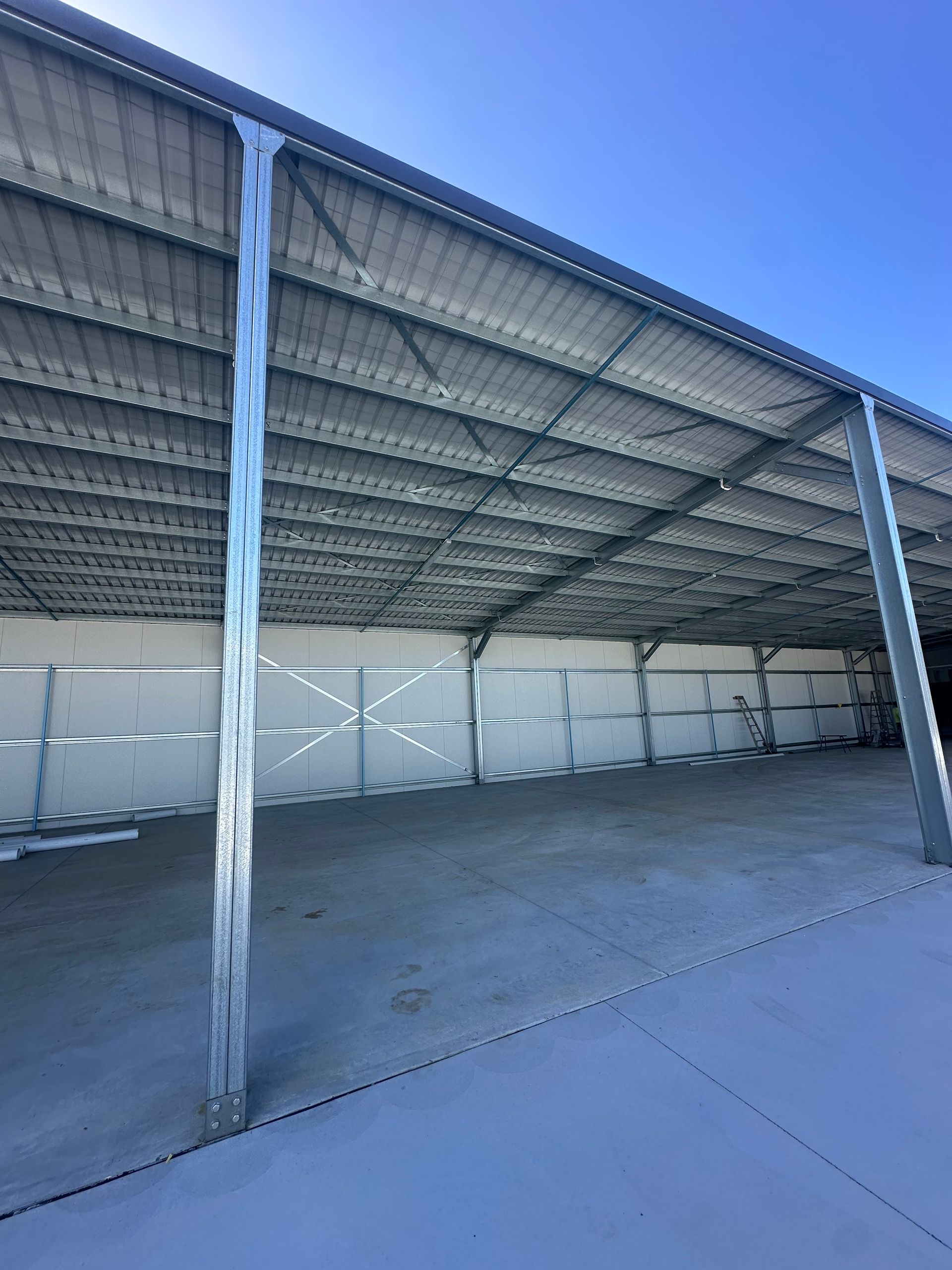 Empty Metal-roofed Warehouse With Concrete Floor And Open Side — Midcoast Premium Caravan Storage in Mid North Coast, NSW
