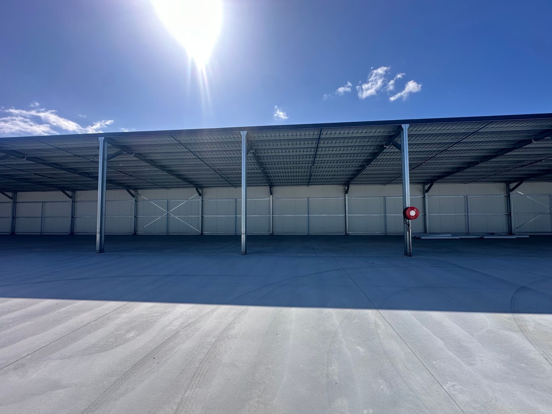Open-air Storage Facility With a Metal Roof, Metal Support Poles — Midcoast Premium Caravan Storage in Forster, NSW