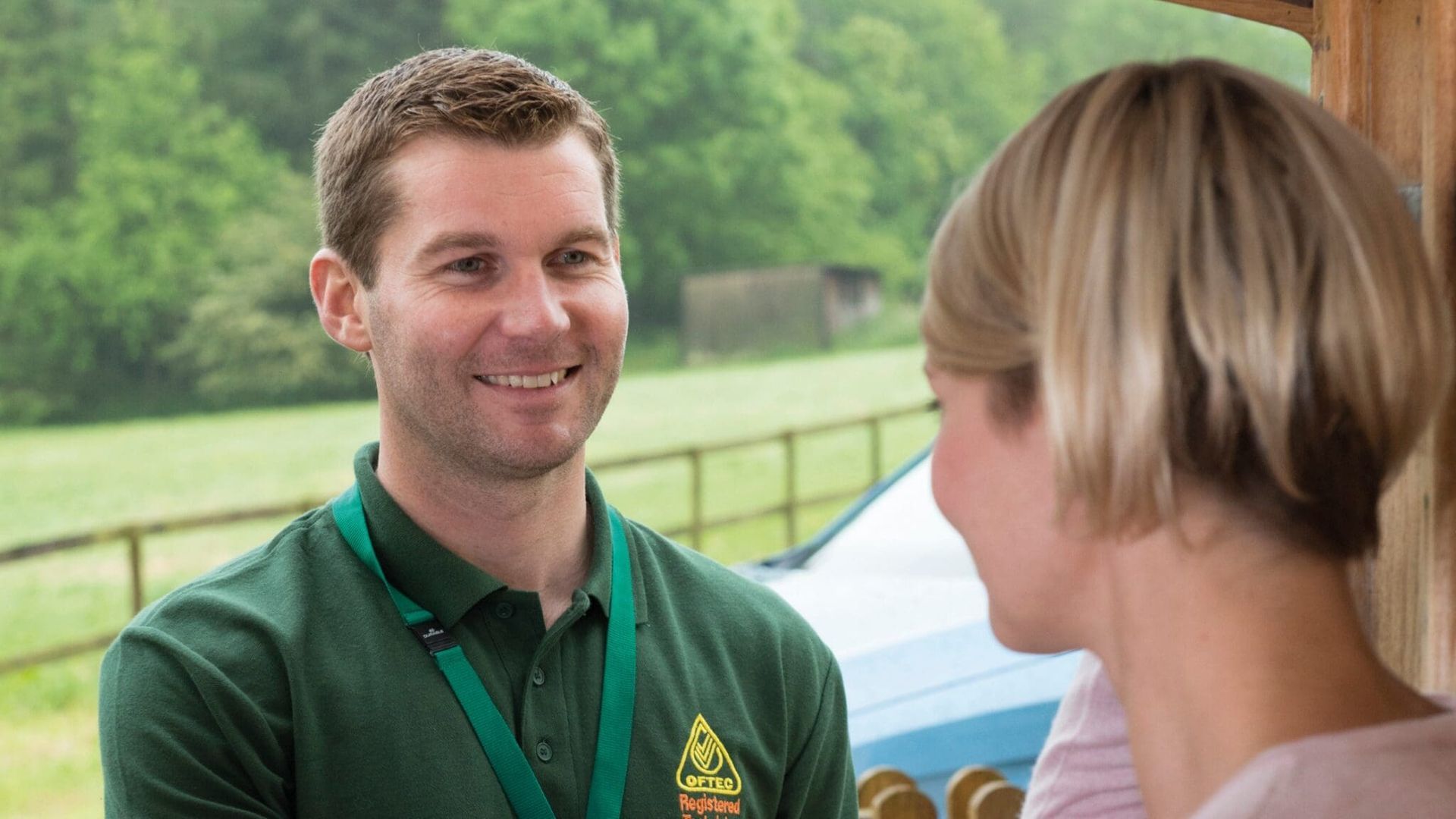 Photograph of a male OFTEC Registered Technician greeting a householder.