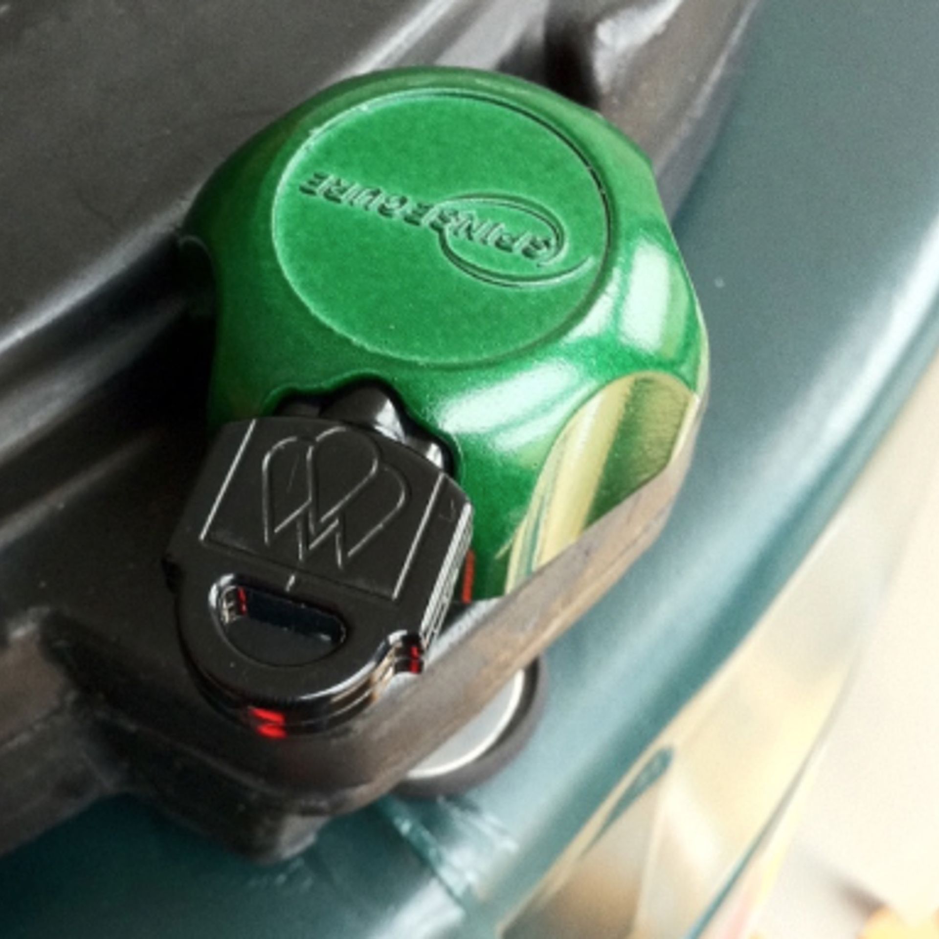 Lockable lids are an affordable and can help reduce the risk of opportunist heating oil theft. Photograph of a SpinSecure oil tank lock, fitted to a Harlequin plastic bunded heating oil tank.