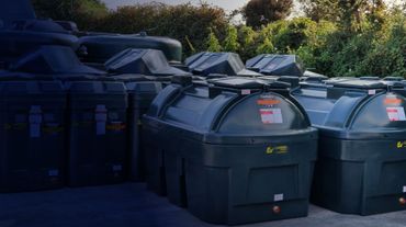 Photograph of a selection of Carbery Heating Oil Tanks sitting in a yard. 