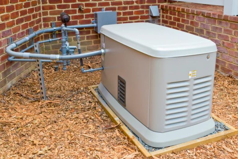 Outdoor backup generator beside brick building with circular metal utility piping