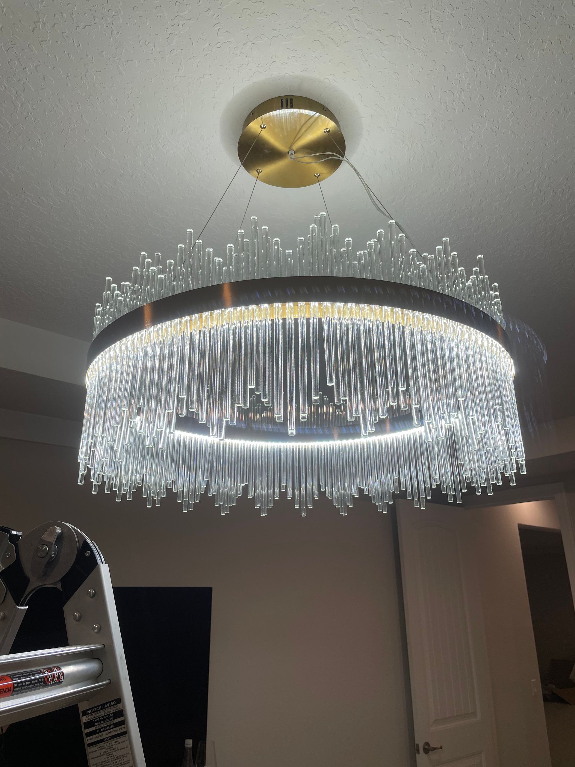 Crystal ring chandelier with dangling lights hanging from a ceiling in a room