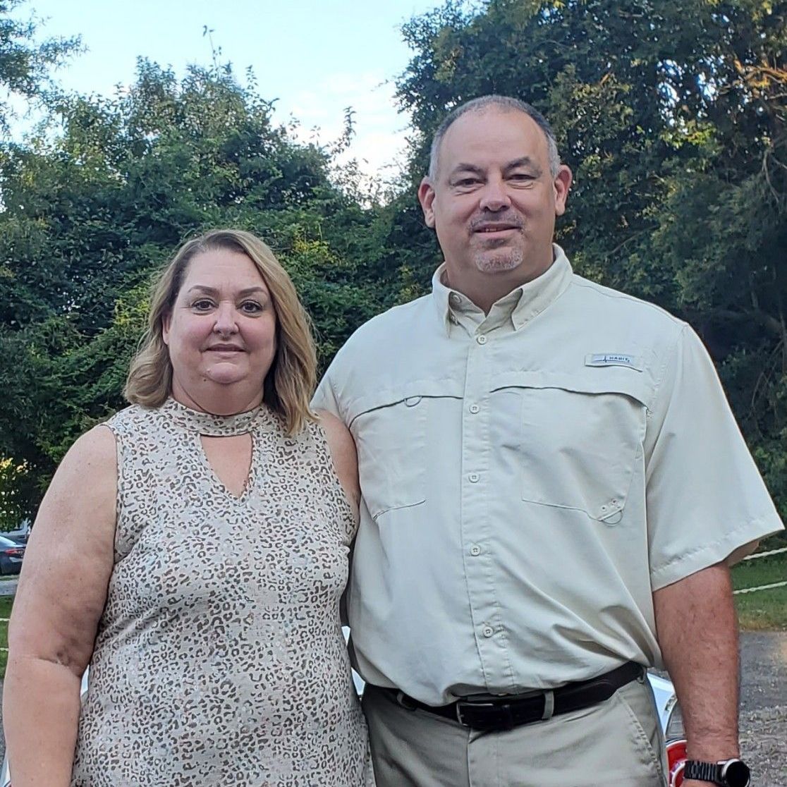 A man and a woman are posing for a picture together.