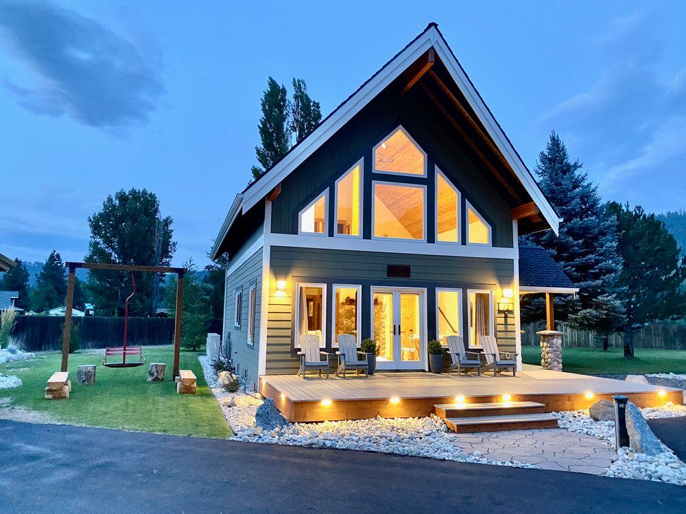 A house with a lot of windows is lit up at night