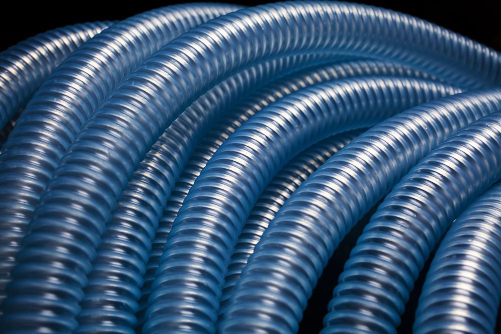A Close Up Of A Bunch Of Blue Hose On A Black Background — NQPT In Garbutt, QLD