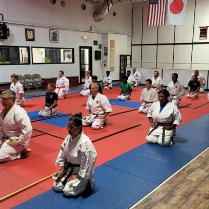 A group of people are practicing martial arts in a gym