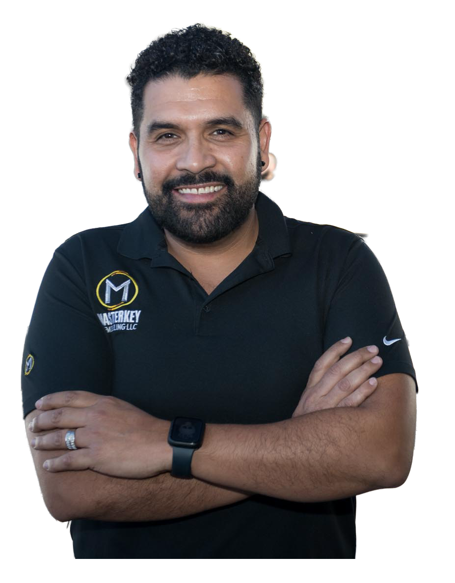 A man wearing a black shirt with the letter m on it
