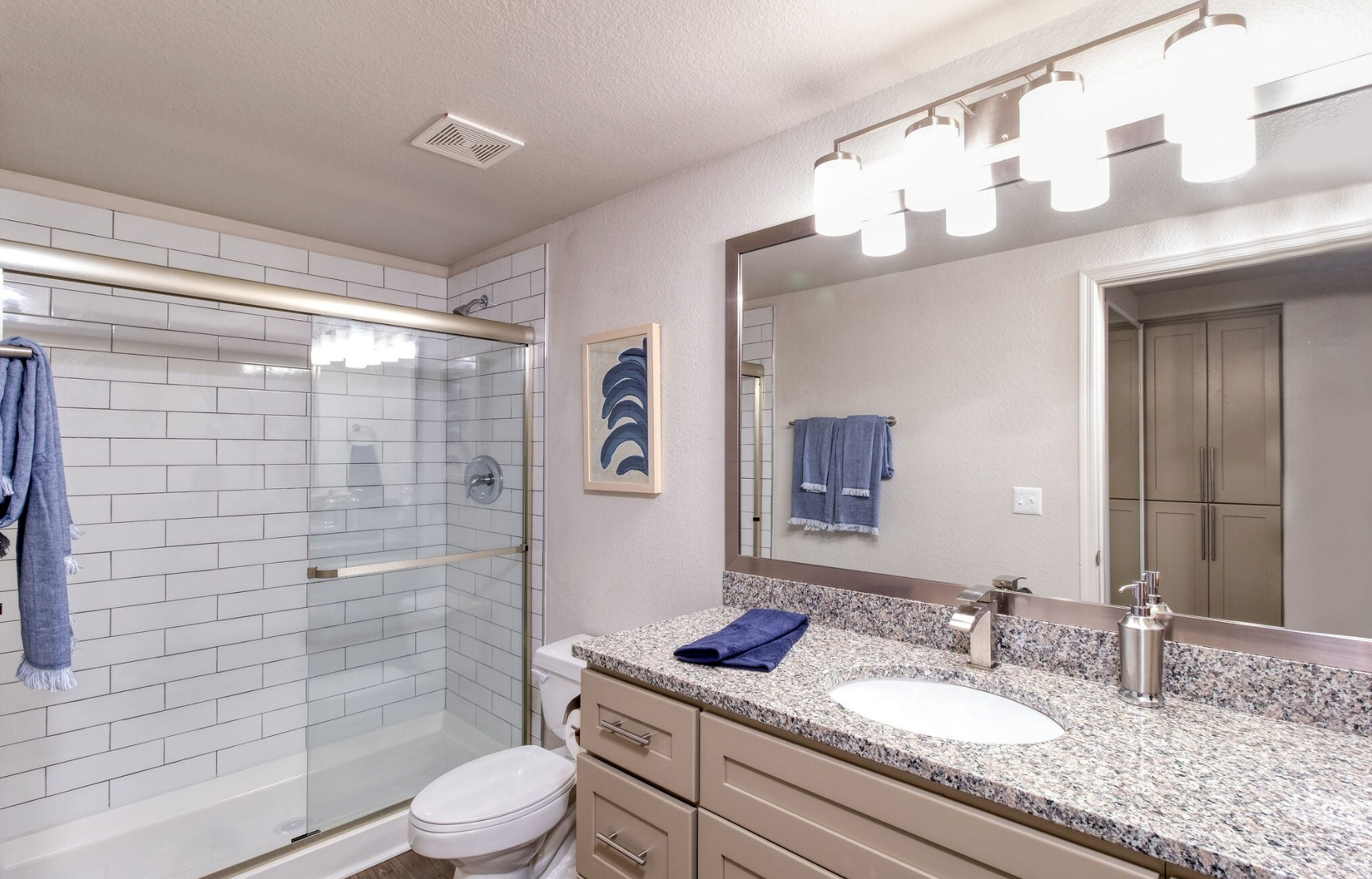 A bathroom with a toilet , sink , and shower.