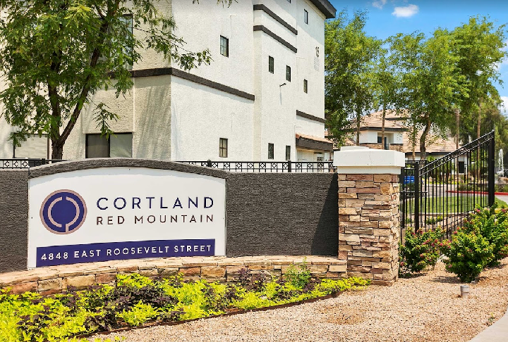 A white building with a sign that says cortland red mountain on it.