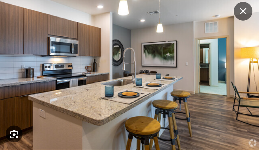 A kitchen with a large island and stools